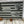 Load image into Gallery viewer, Close up of right side of flag showing three scenes from 1st Cav in Vietnam War. The top scene shows two soldiers, one of which is talking on the radio calling in artillery fire. The next scene is of five helicopters landing and picking up soldiers and the last scene is a squad of soldiers on line fight the enemy in a fire fight.