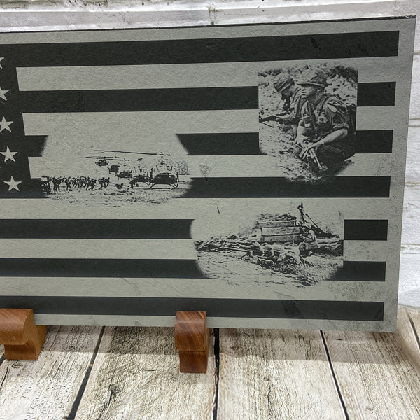 Close up of right side of flag showing three scenes from 1st Cav in Vietnam War. The top scene shows two soldiers, one of which is talking on the radio calling in artillery fire. The next scene is of five helicopters landing and picking up soldiers and the last scene is a squad of soldiers on line fight the enemy in a fire fight.