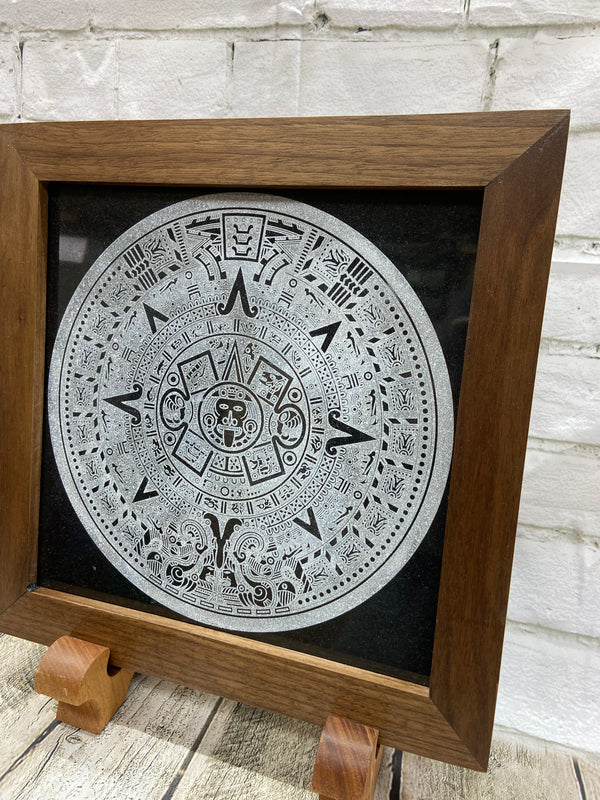 Aztec Calander laser engraved onto a piece of black granite. Then framed with a handcrafted black walnut frame with walnut splines.
