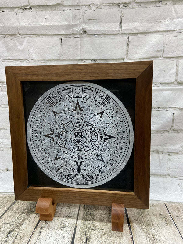 Aztec Calander laser engraved onto a piece of black granite. Then framed with a handcrafted black walnut frame with walnut splines.