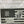 Load image into Gallery viewer, A close up of the left side of the product showing the 10th Mountain patch in the US flag union section and two scenes on the stripes. One scene is of the 10th Mountain soldiers climbing the mountains in Riva Ridge, Italy and the other is of five 10th Mountain soldiers with their ski gear getting ready to patrol in Riva Ridge area in Italy.