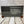 Load image into Gallery viewer, A scene of New York city skyline and the Statue of Liberty on the US flag. All laser engraved onto a piece of black slate.