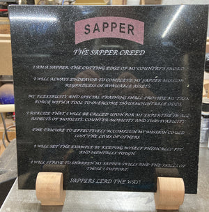 The Sapper Creed laser engraved onto a piece of black granite. After engraving it was color filled the Sapper tab red and the creed lettering white.