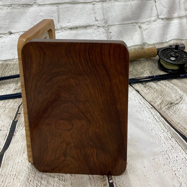 A curly maple and chechen wooden fly box able to hold 80 flies. Finished with Total Boat halcyon to a very nice polish finish.