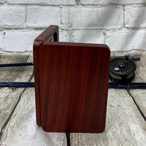 This fly box is made with a beautiful wood called pad-auk. Hinged with a barrel hinges, and earth magnets to hold close to give it a sleek look. Fly box can hold up to 80 flies depending on types of flies. This fly box will show everyone on the water, you love fly fishing and do it in style! This fly box measurements are 4 5/8 inch wide x 6 7/8 inch length x 1 1/8 deep. All fly boxes are finished in Total Boat halcyon clear varnish.