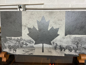 Canadian Army and Canadian Royal Marines on D-day Juno Beach on the Canadian flag, laser engraved onto a 24 inch by 12 inch piece of black slate. Being displayed on two mahogany wooden stands.