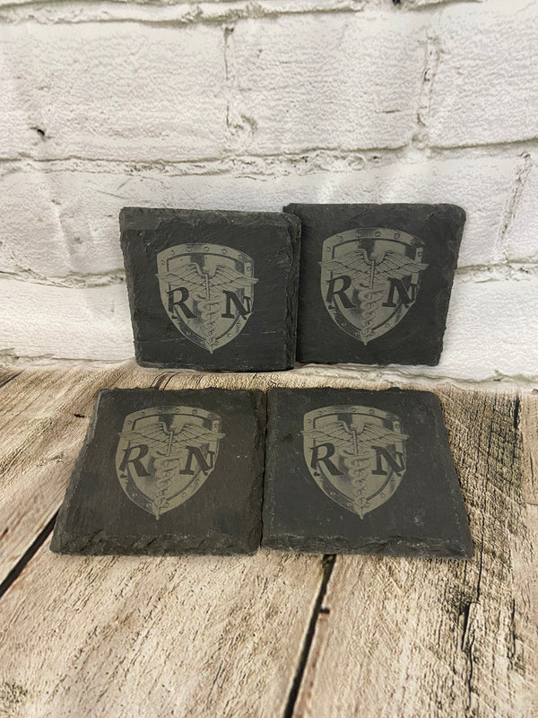 Four slate coasters laser engraved with a RN shield logo.
